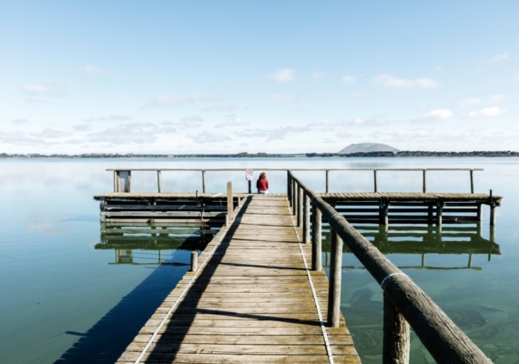 Person sitting at the end of the jetty at Lake Tooliorook
