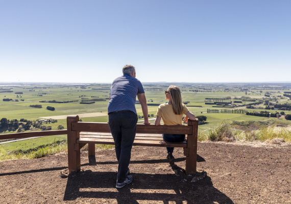 Image of a couple on a bench on Mount Leura overlooking the Corancamite Shire plains